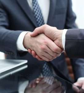 business men shaking hands after closing an insurance agreement