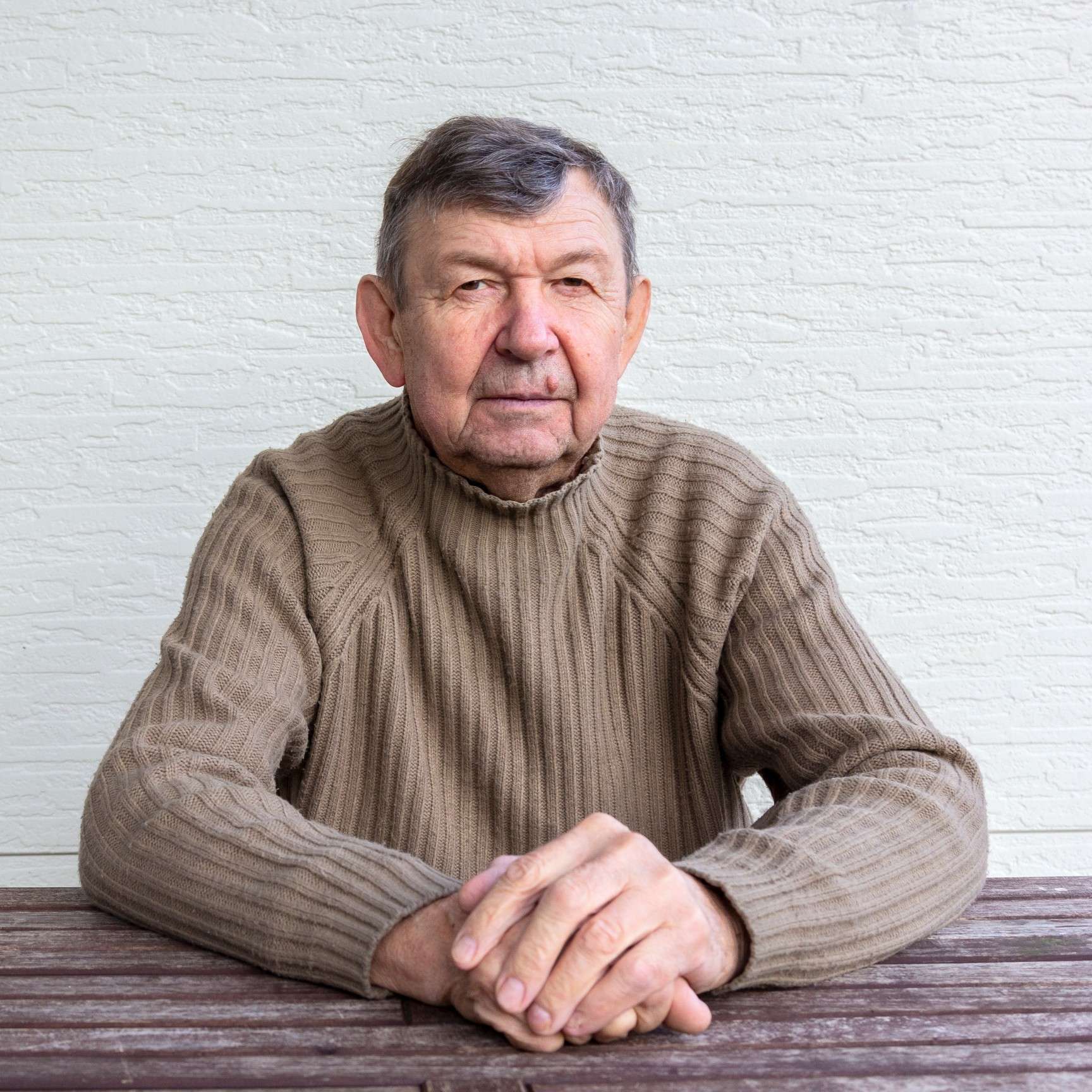 portrait-of-elderly-man-looking-at-camera-old-senior-crossed-wrinkled-hands-close-up-of-face-copy_t20_7mwGQ6