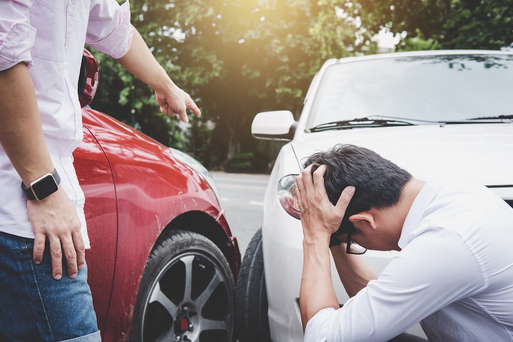 Stressed driver on roadside after car accident on dangerous road