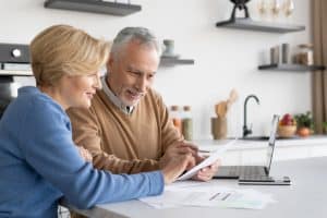 older couple looking over social security OASDI supplement check