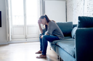 young woman showing signs of emotional distress iied