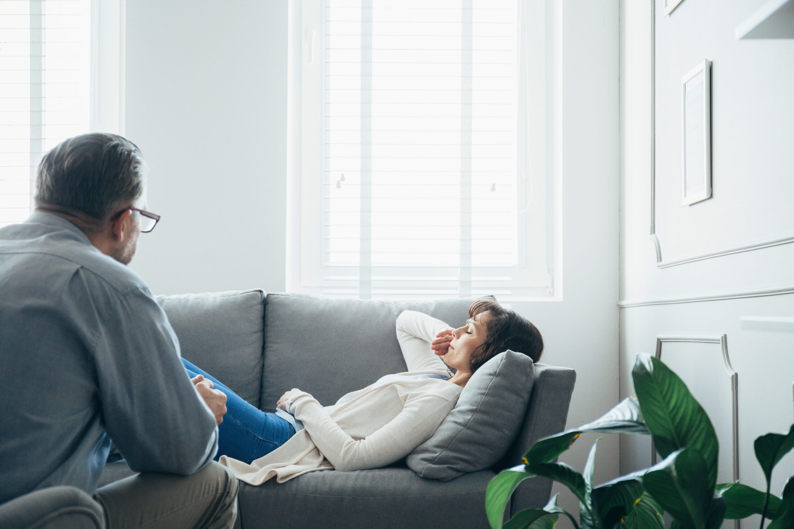 young woman in therapy showing signs of emotional distress iied