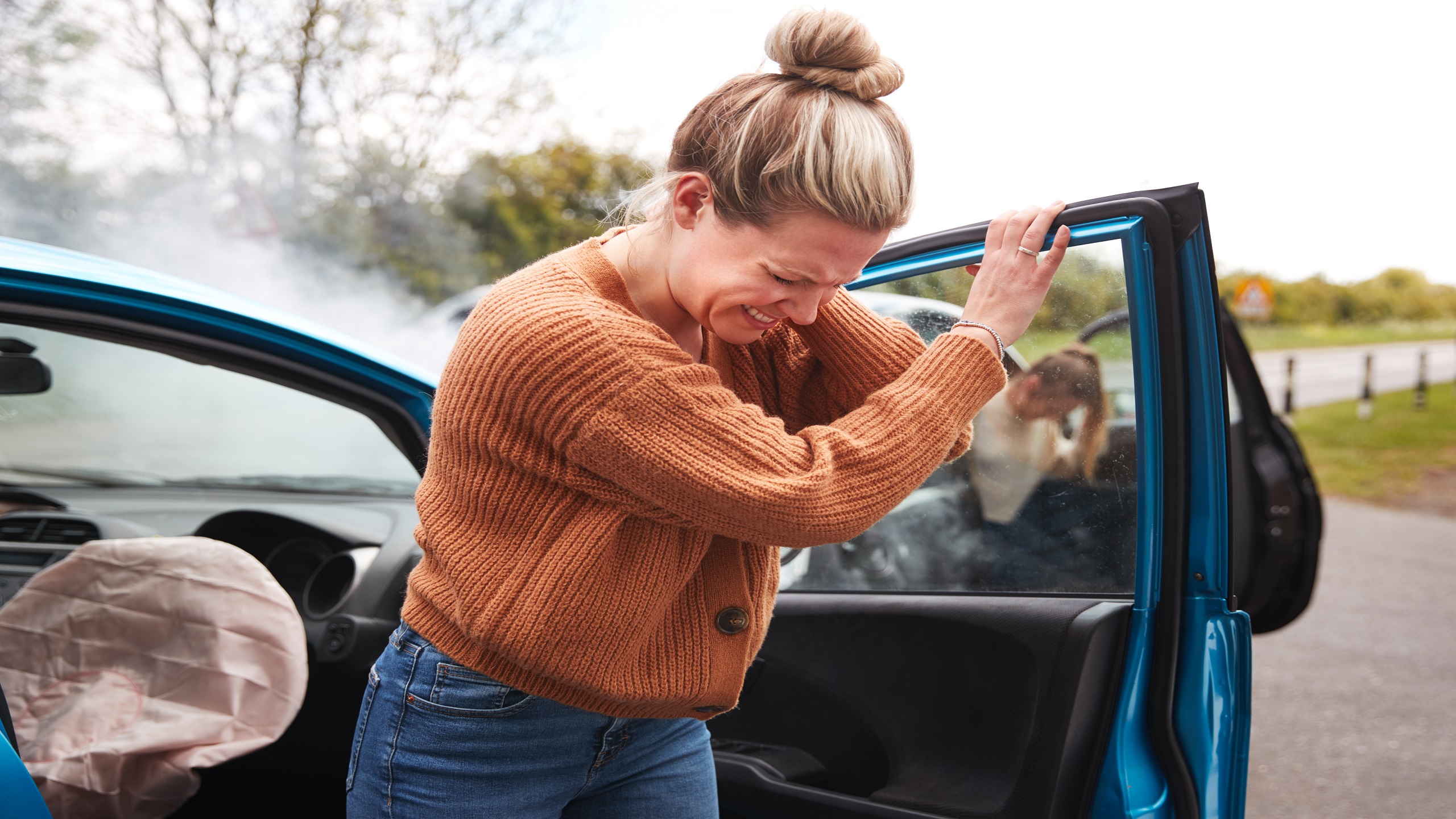 woman exiting a car accident with personal injury