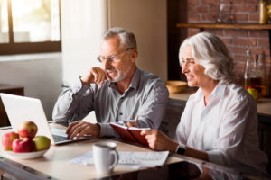 retired couple applying for social security benefits and life insurance on the computer with new ssa work history requirements and occupations list