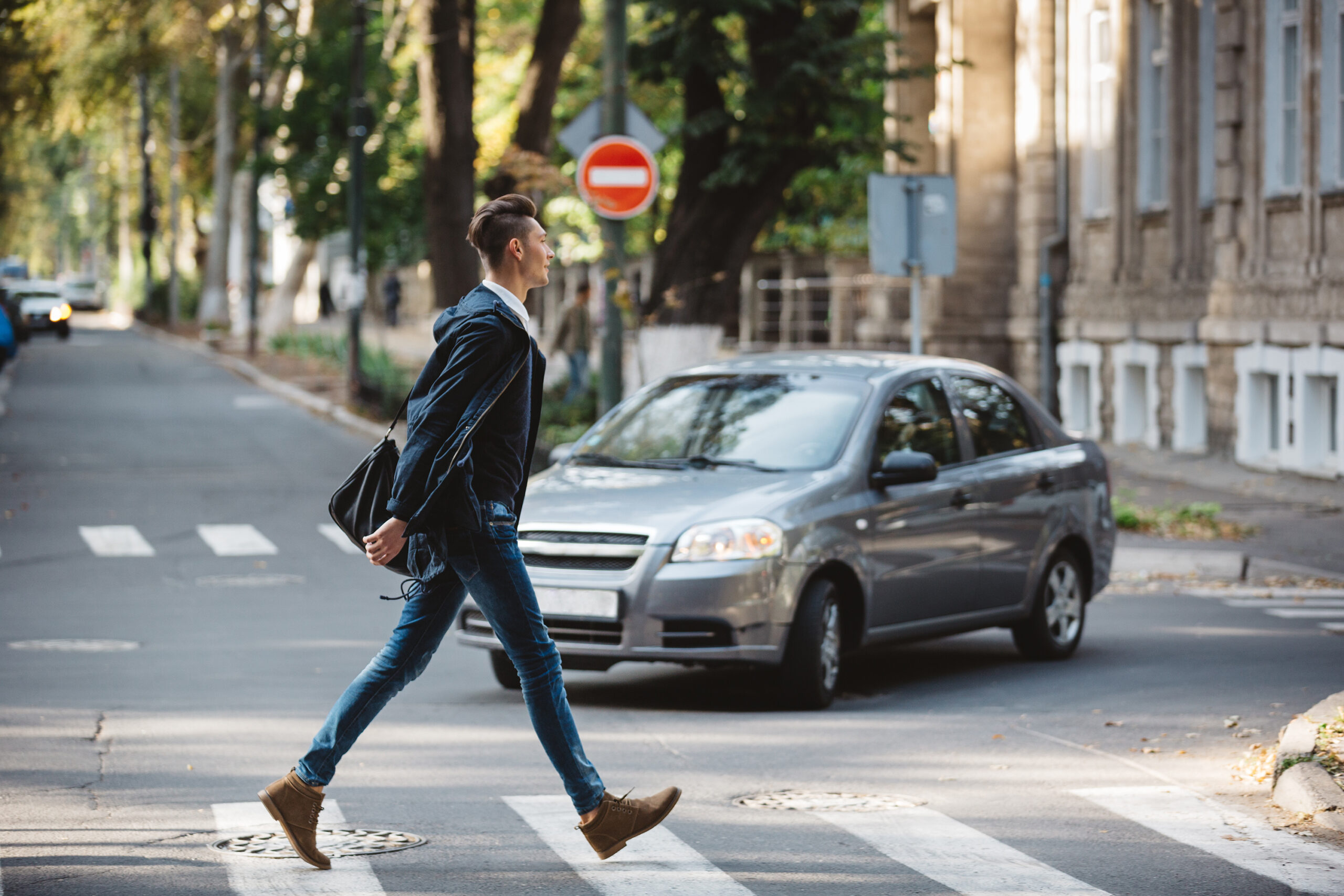 pedestrian crossing the street with car coming possible pedestrian accident