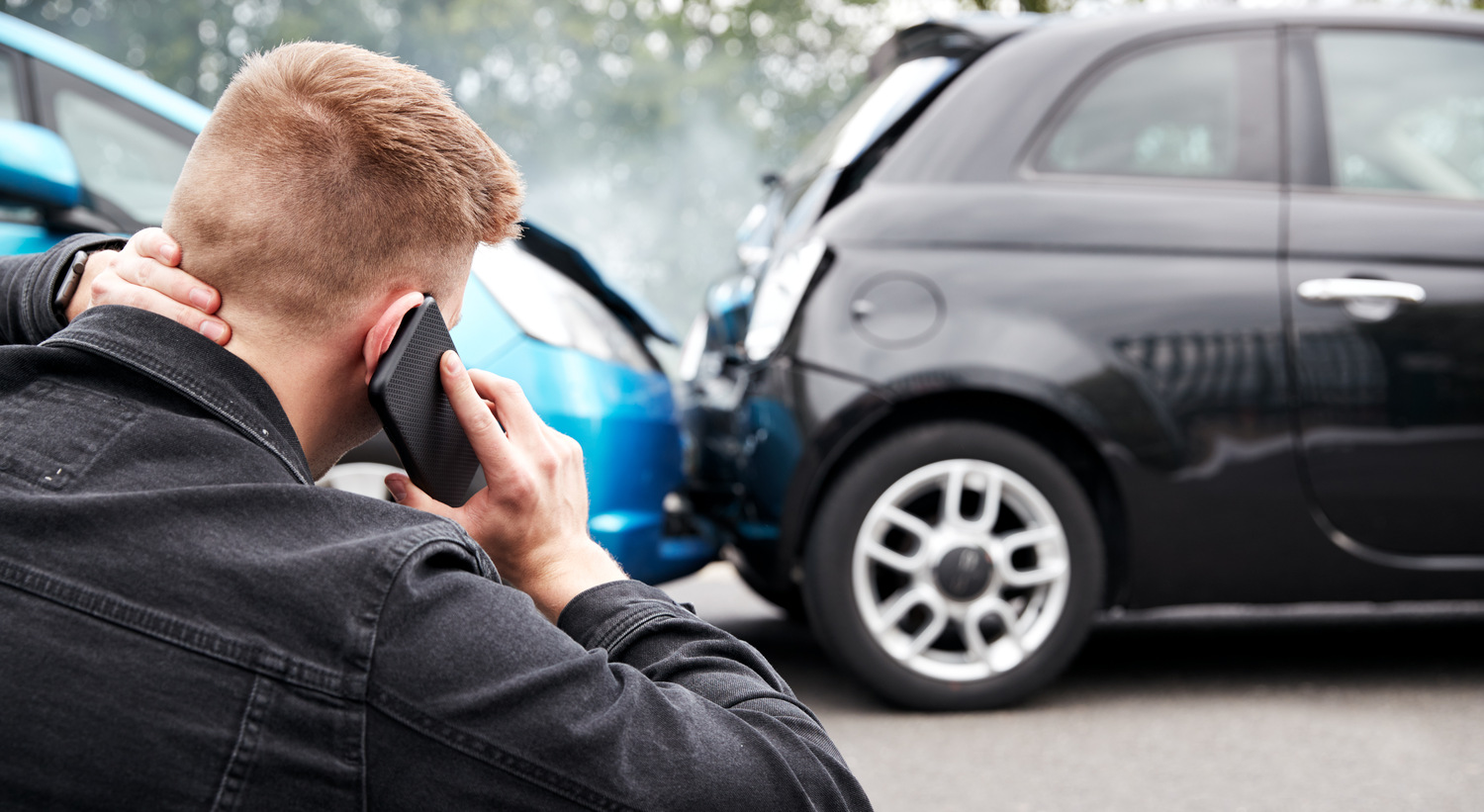 learning-about-uber-accident-settlement man on phone after uber accident to learn about settlement