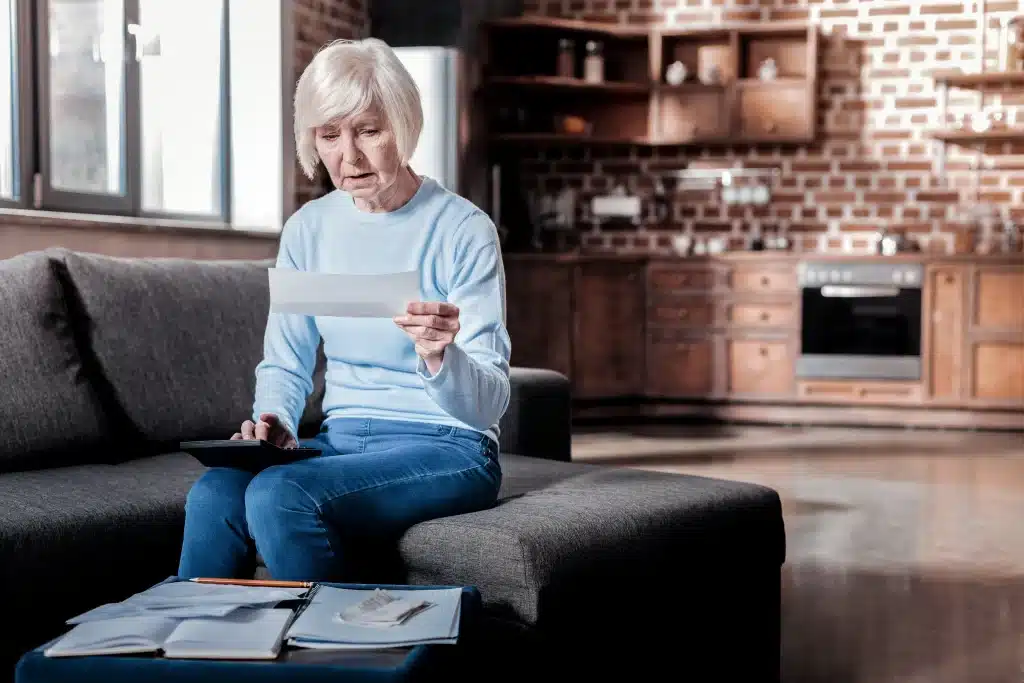 Social Security Lawyers woman looking at a piece of mail during an insurance claim and subrogation