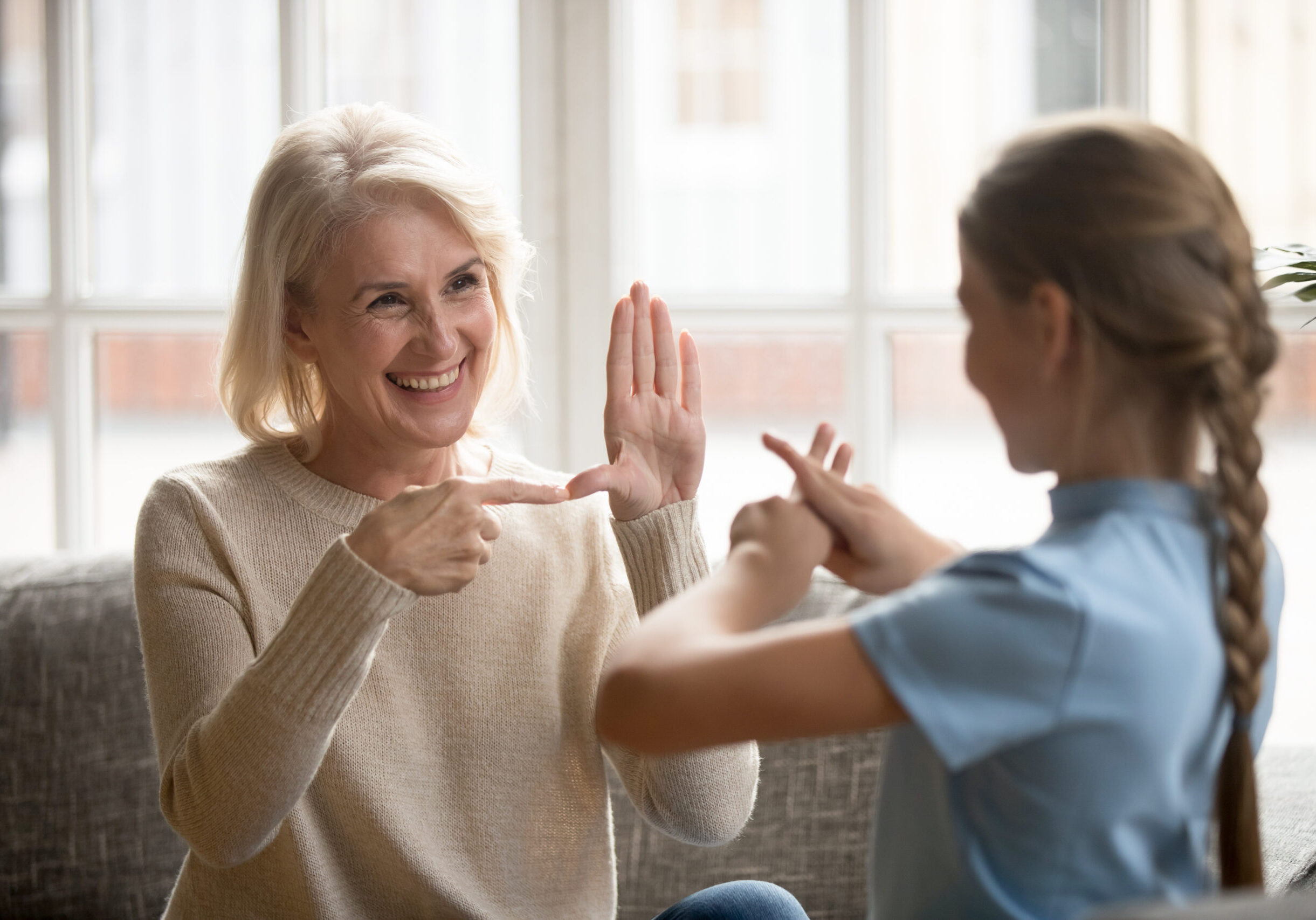 deaf special needs child signing with adult