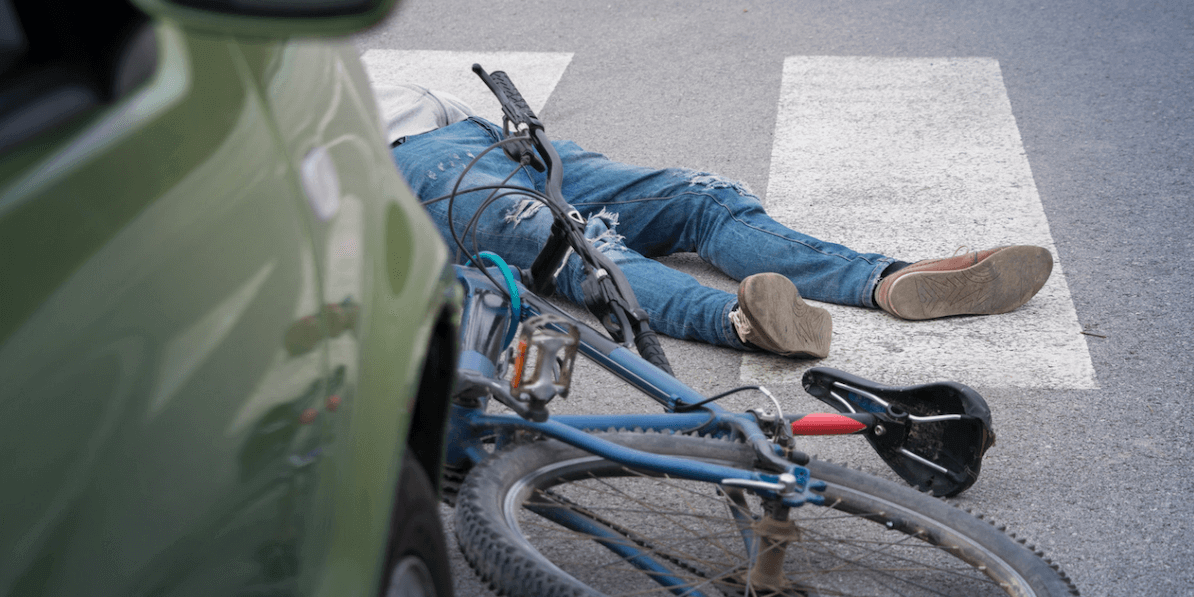 victim on the ground after a bicycle accident lawyer