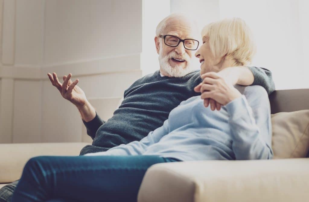 Older couple talking on a couch
