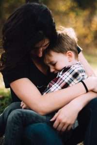 child hugging their guardian; child injury lawyer