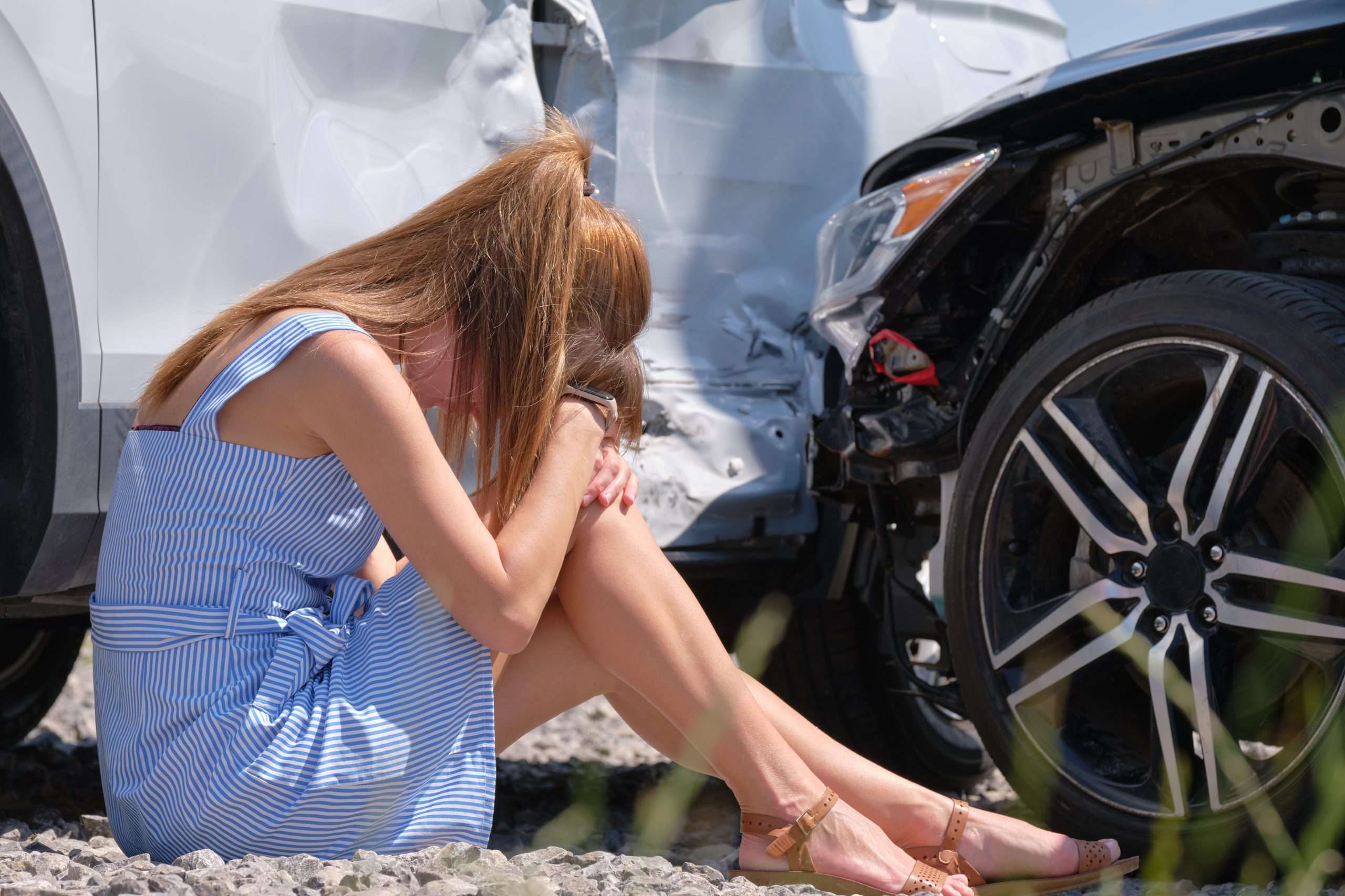 Car accident woman sitting in emotional distress after a wreck