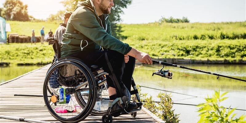 man with a disability fishing after his claim was denied