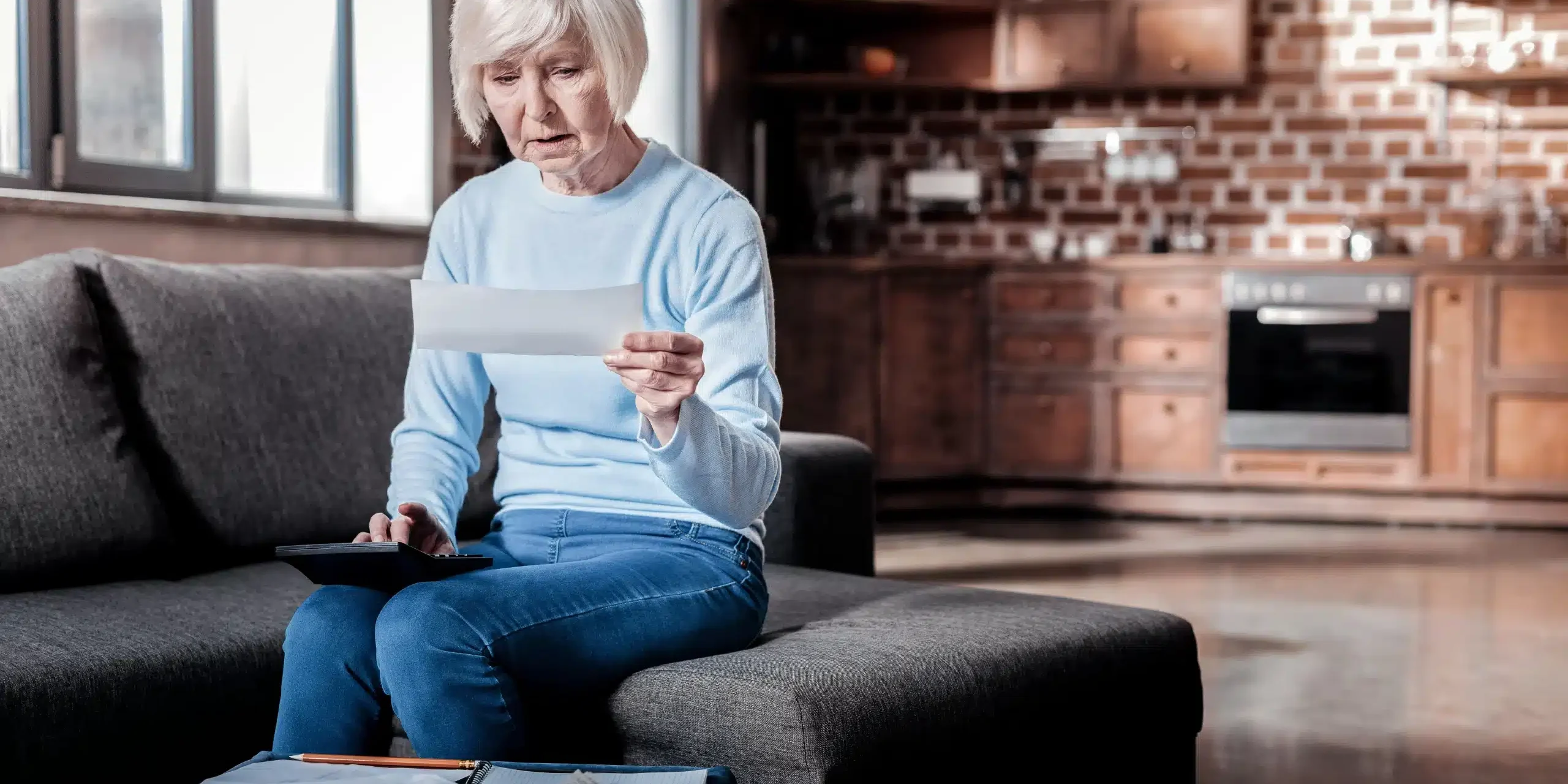 Social Security Lawyers woman looking at a piece of mail during an insurance claim and subrogation