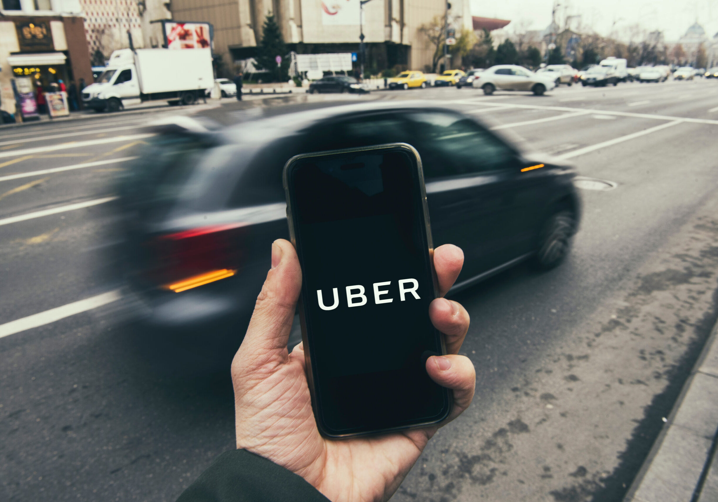 Bucharest, Romania - December 22: Man holding a smart phone with Uber app.