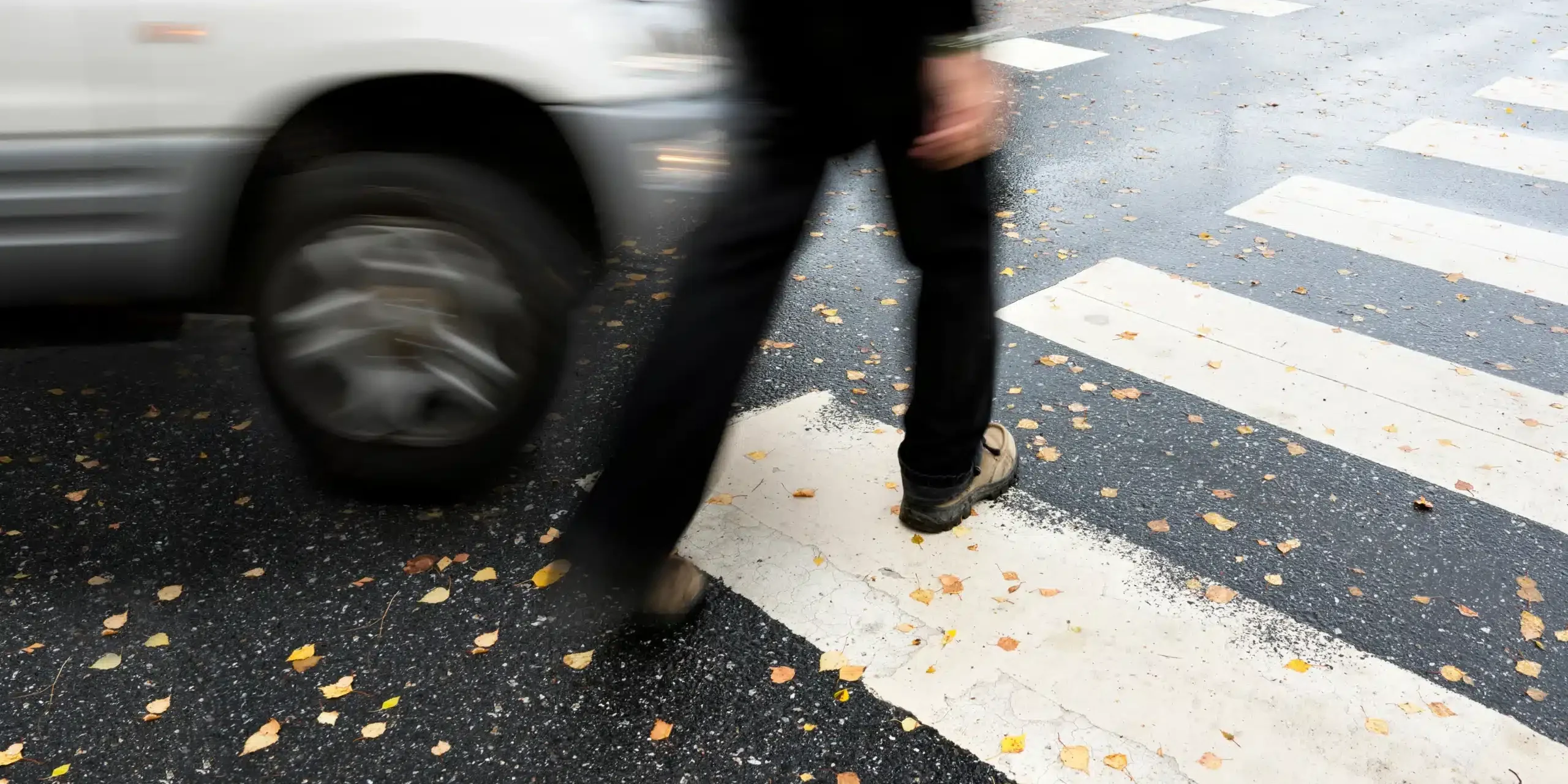 man crossing the road being hit by a car; pedestrian accident