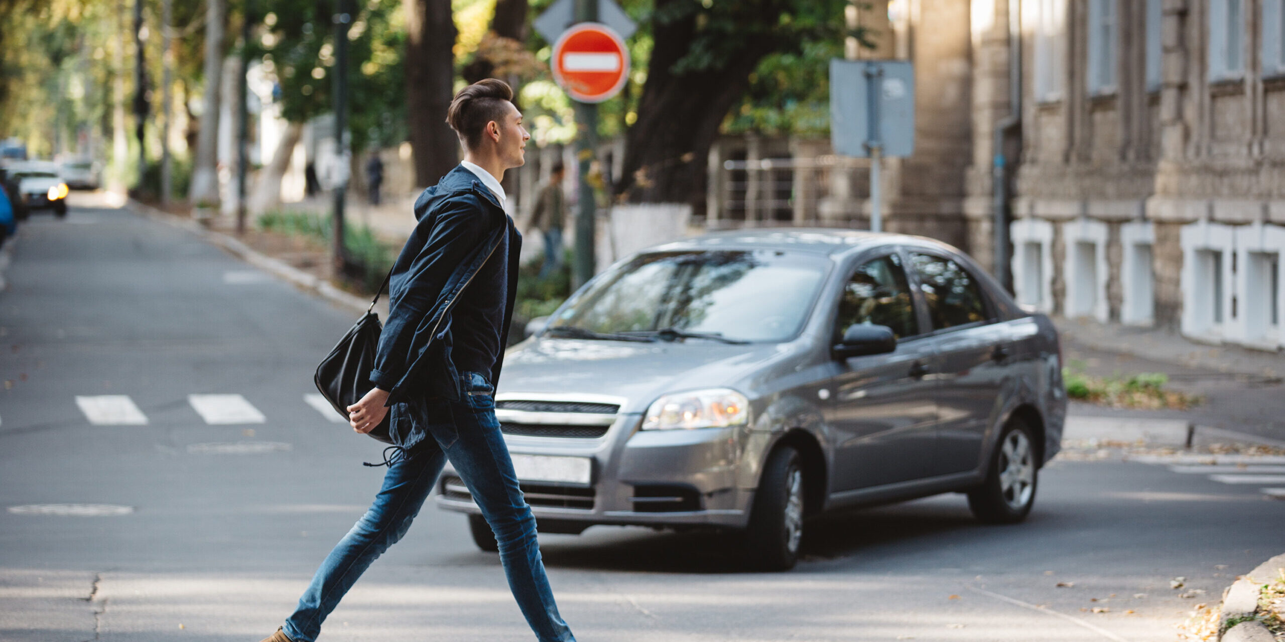 pedestrian crossing the street with car coming possible pedestrian accident